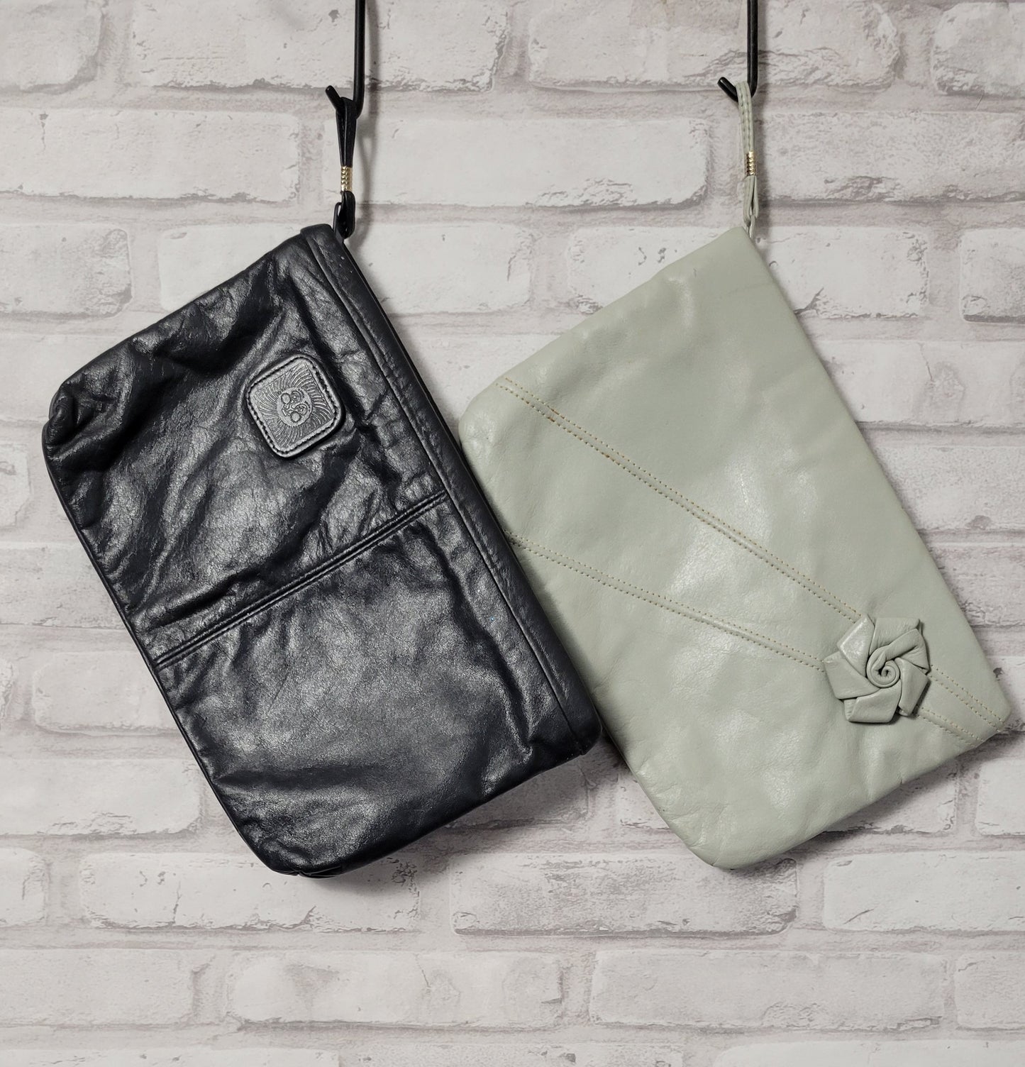 Pair of 1980s leather clutch bags -- navy blue and dove gray
