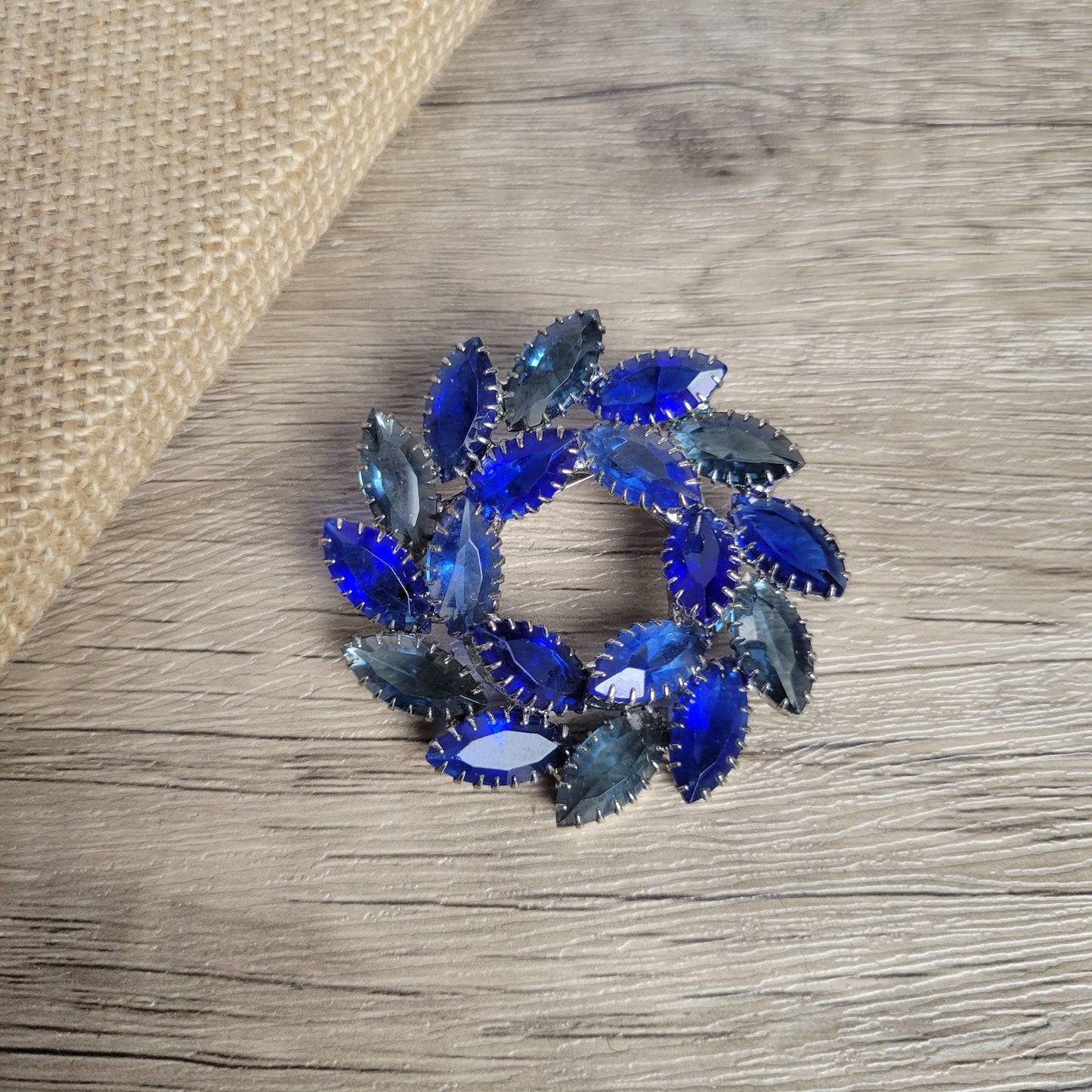 Vintage brooch blue glass open-back rhinestone circle or wreath dogtooth prongs