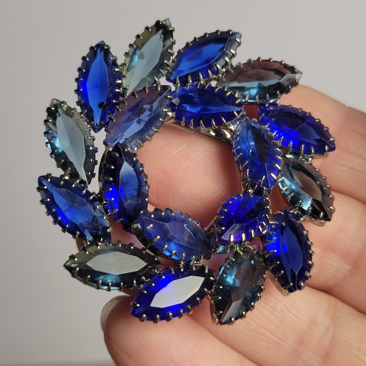 Vintage brooch blue glass open-back rhinestone circle or wreath dogtooth prongs